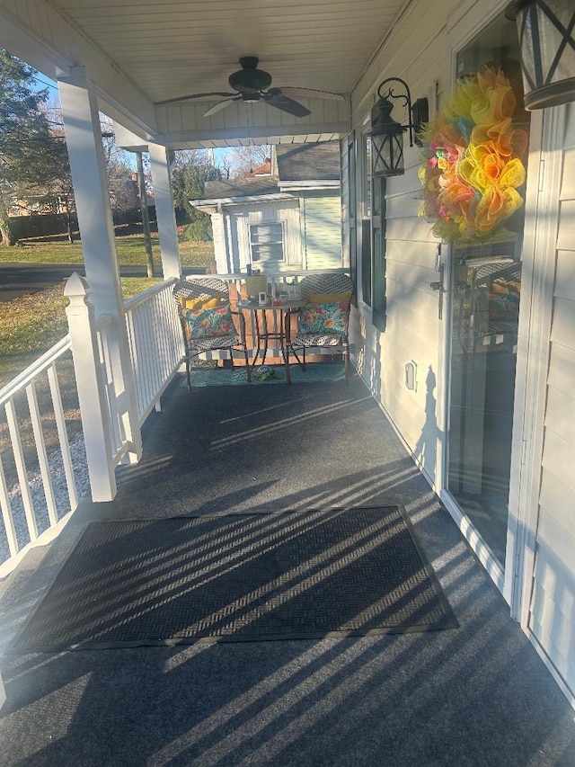 deck featuring covered porch and ceiling fan