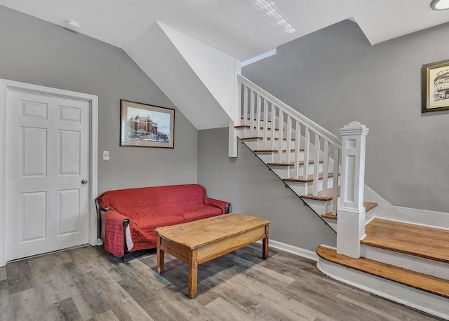 sitting room with light hardwood / wood-style flooring and lofted ceiling