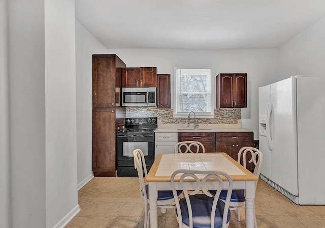 kitchen with black range with electric stovetop, dark brown cabinetry, white fridge with ice dispenser, sink, and backsplash