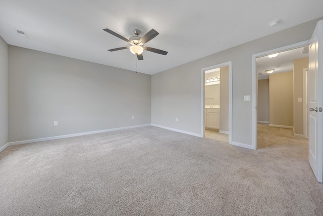 unfurnished bedroom with connected bathroom, ceiling fan, and light colored carpet