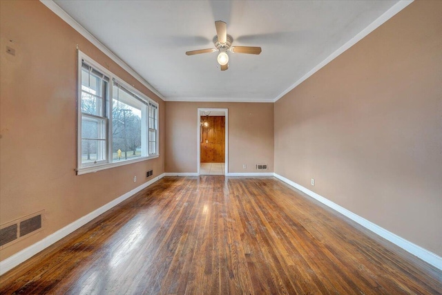 unfurnished room featuring dark hardwood / wood-style flooring, ceiling fan, and ornamental molding