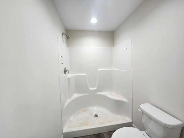 bathroom featuring toilet and walk in shower