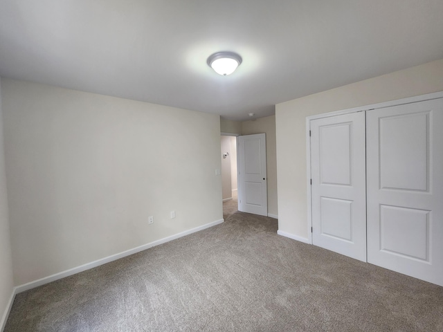 unfurnished bedroom with carpet and a closet