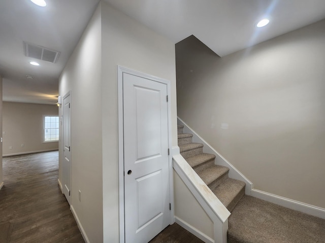 stairway with hardwood / wood-style flooring