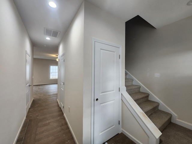 staircase with hardwood / wood-style floors