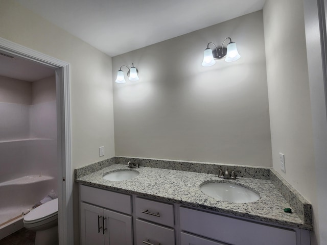 bathroom featuring vanity, toilet, and walk in shower