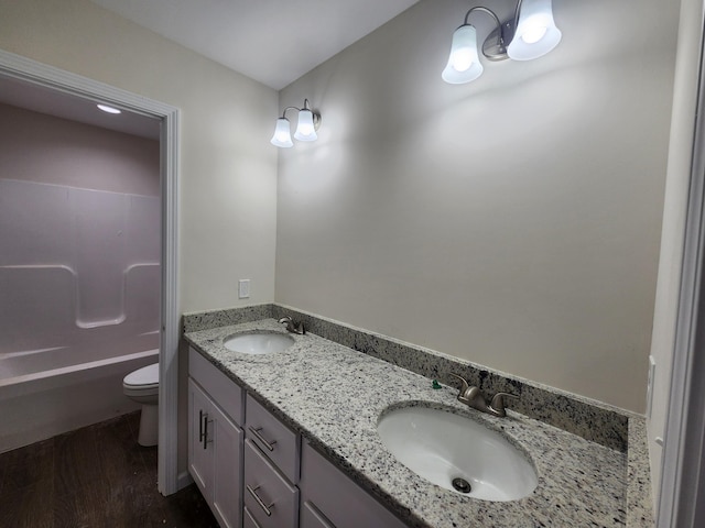 bathroom with vanity, toilet, and wood-type flooring