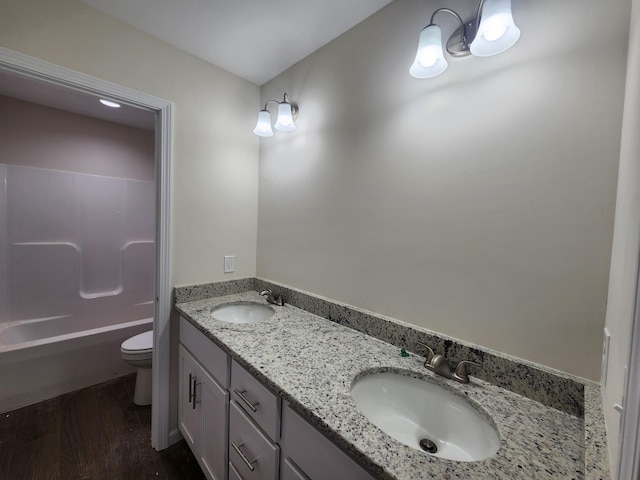 bathroom featuring hardwood / wood-style floors, vanity, and toilet