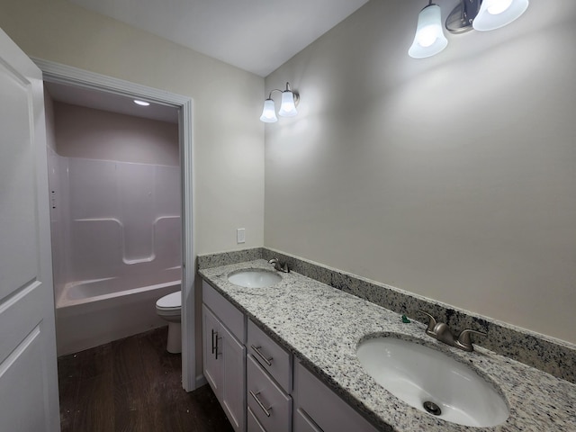 full bathroom featuring shower / bathing tub combination, vanity, wood-type flooring, and toilet