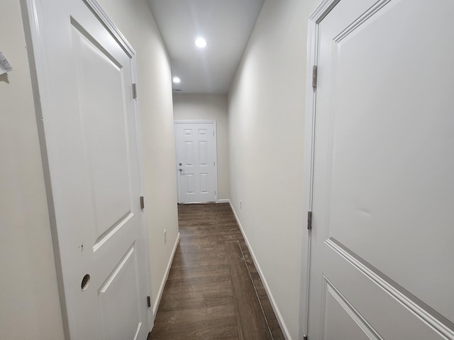 hallway with dark hardwood / wood-style floors