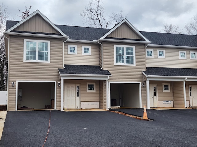 multi unit property featuring a garage