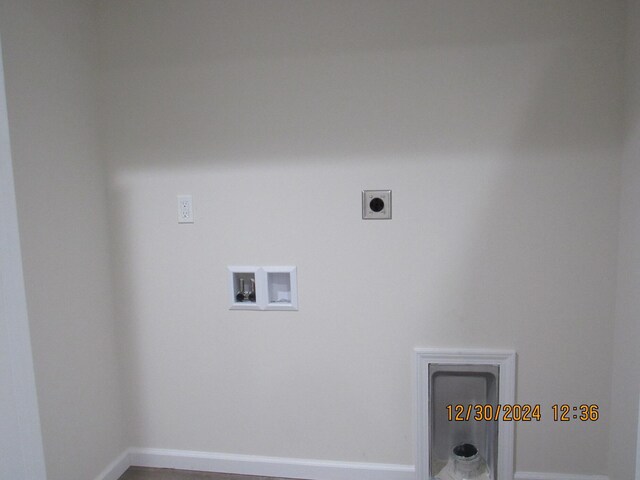 clothes washing area with baseboards, laundry area, washer hookup, and hookup for an electric dryer