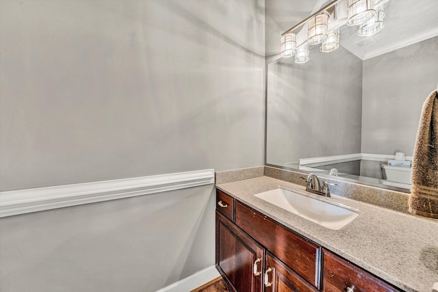 bathroom featuring crown molding and vanity