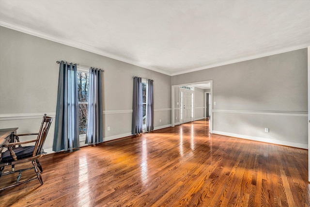 spare room featuring dark hardwood / wood-style floors and crown molding