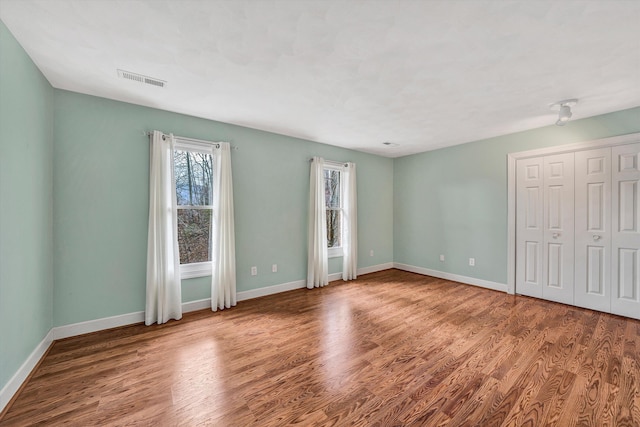 spare room with hardwood / wood-style floors