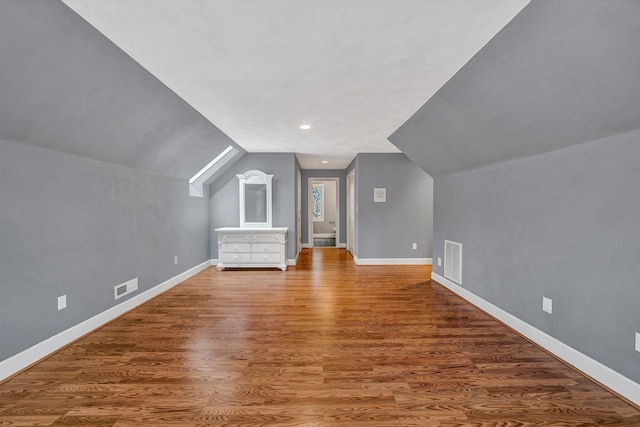 bonus room with wood-type flooring and lofted ceiling