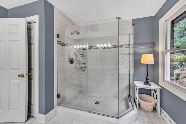 bathroom featuring tile patterned flooring, walk in shower, and a wealth of natural light