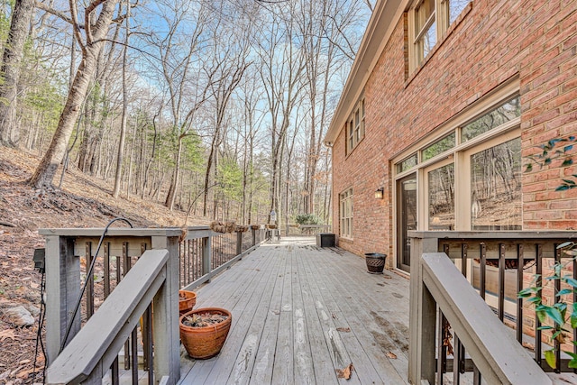 wooden terrace featuring central AC unit