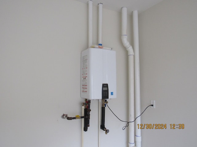 utility room featuring water heater