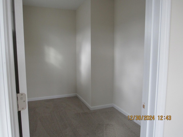 empty room featuring baseboards and carpet flooring