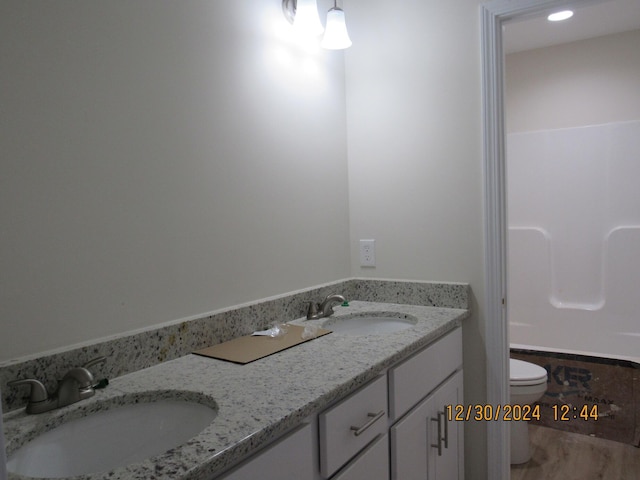 bathroom featuring vanity and toilet