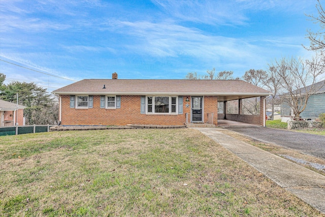 ranch-style house featuring a carport and a front lawn