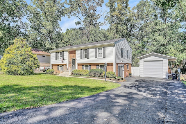 raised ranch featuring a front lawn, an outdoor structure, and a garage