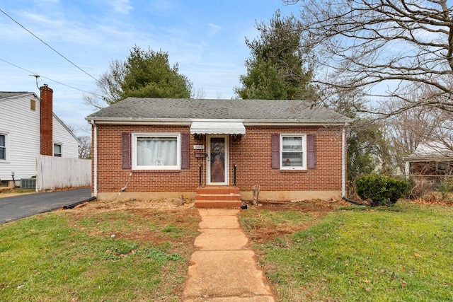 bungalow-style home featuring central AC unit and a front yard