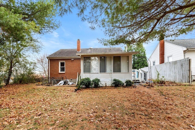 rear view of property with a sunroom