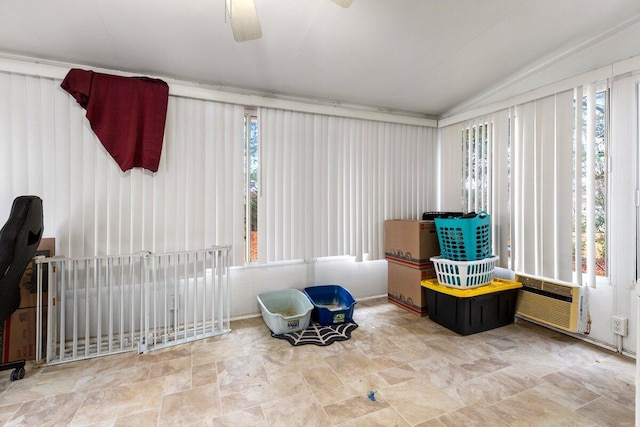 sunroom with a wall mounted air conditioner, ceiling fan, and vaulted ceiling