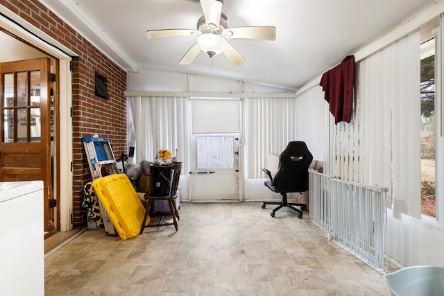 interior space with ceiling fan, lofted ceiling, and brick wall