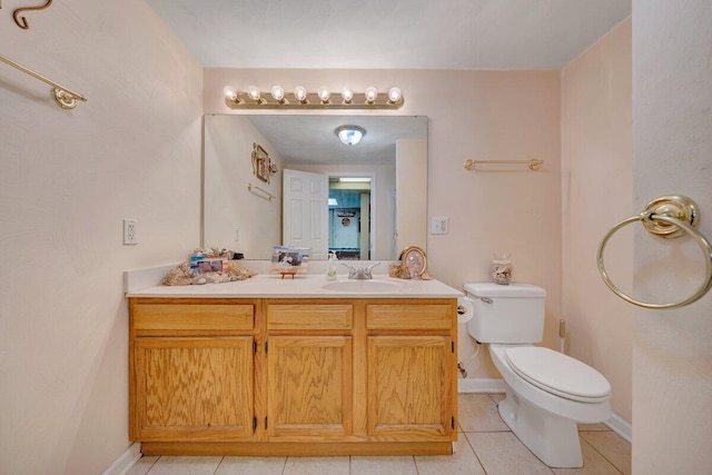 bathroom with tile patterned flooring, vanity, and toilet