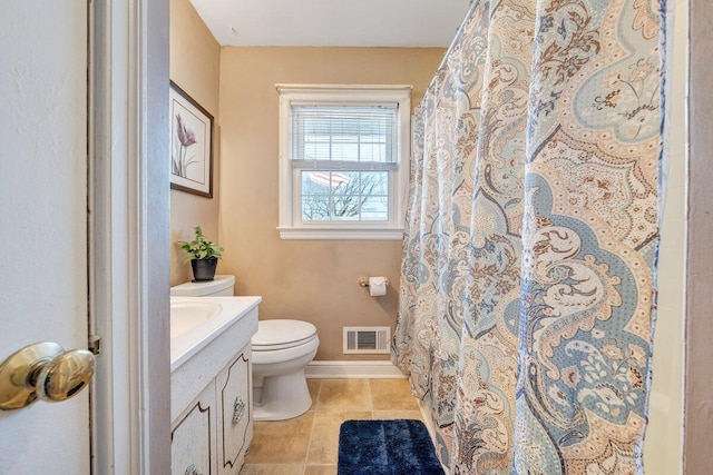 bathroom featuring walk in shower, vanity, and toilet