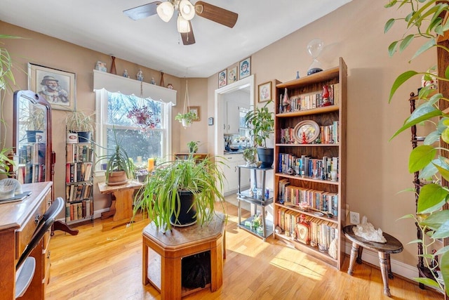 sitting room featuring ceiling fan and light wood-type flooring