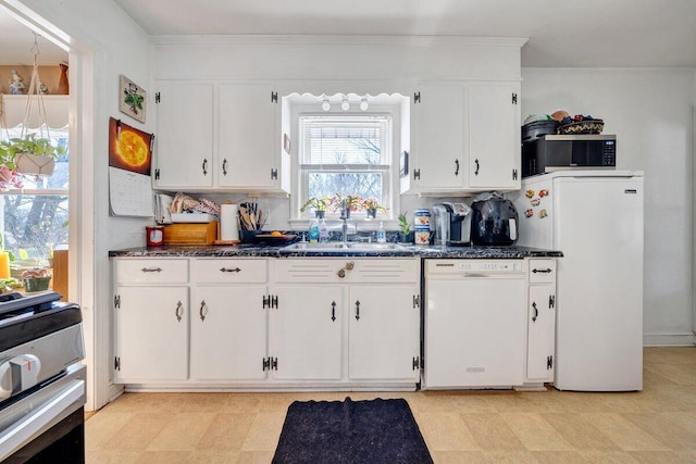 kitchen featuring white cabinets, backsplash, white appliances, and sink