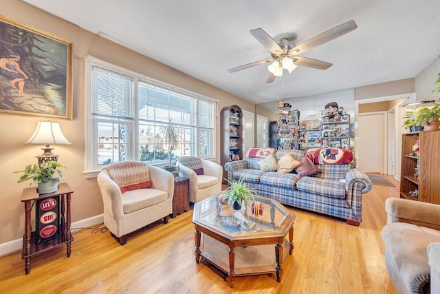 living room featuring ceiling fan and light wood-type flooring