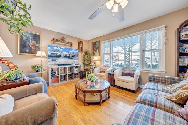 living room with light wood-type flooring and ceiling fan