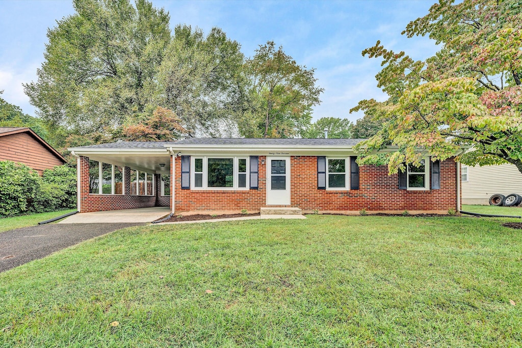 single story home with a front lawn and a carport