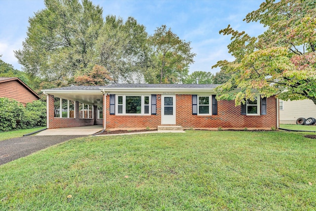 single story home with a front lawn and a carport