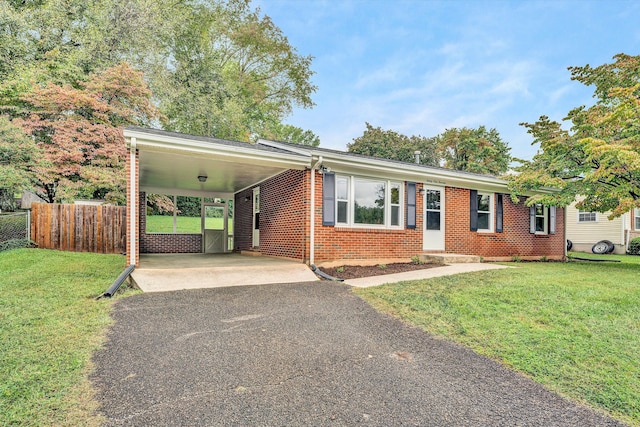 ranch-style home with a front lawn and a carport