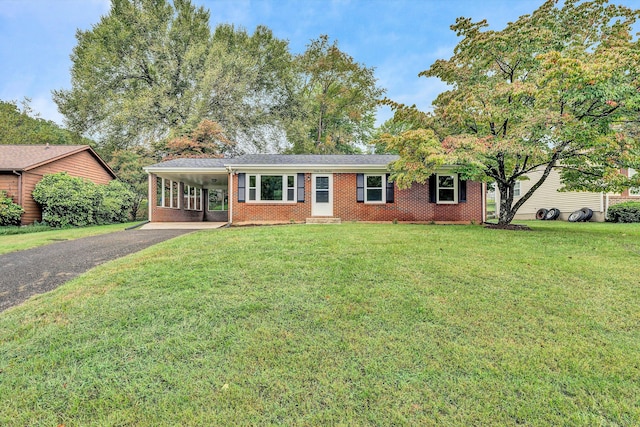 ranch-style home with a front yard and a carport