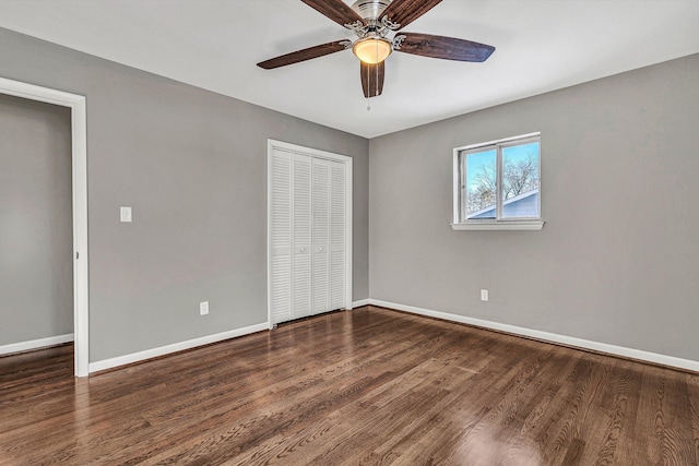 unfurnished bedroom with a closet, ceiling fan, and dark wood-type flooring