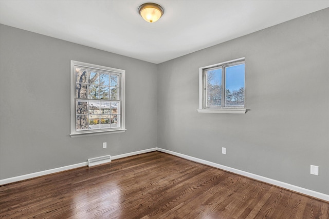 unfurnished room featuring dark hardwood / wood-style floors