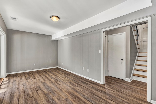 basement with dark hardwood / wood-style floors