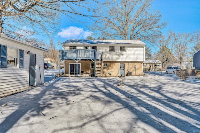 back of property featuring a balcony and a deck