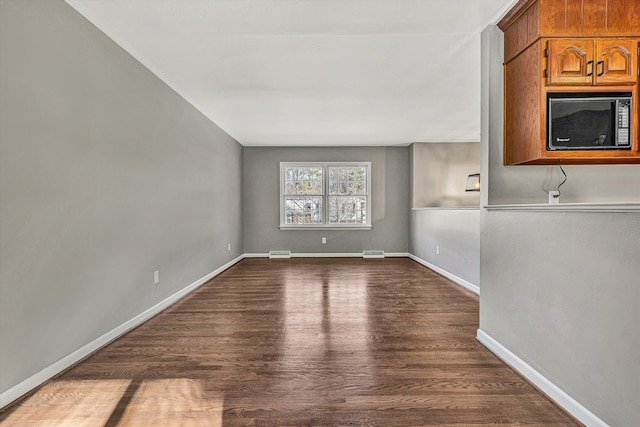 unfurnished living room featuring wood-type flooring