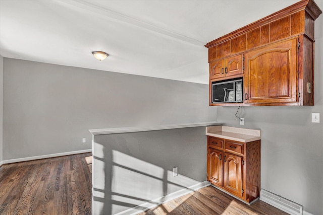 kitchen with dark wood-type flooring