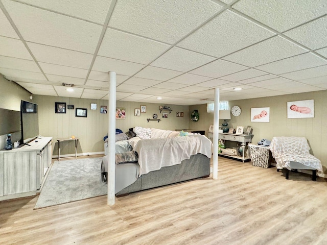 bedroom with hardwood / wood-style floors and a drop ceiling