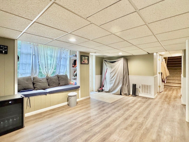 interior space featuring wood-type flooring and a paneled ceiling