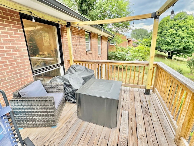 wooden deck featuring area for grilling